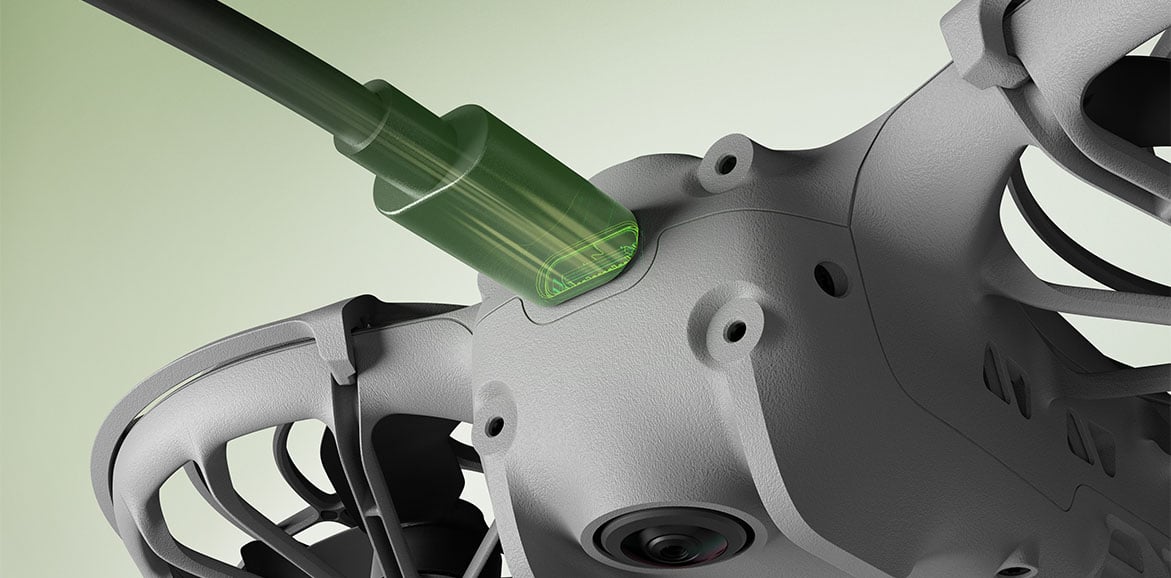 Dron podłączony kablem do ładowania